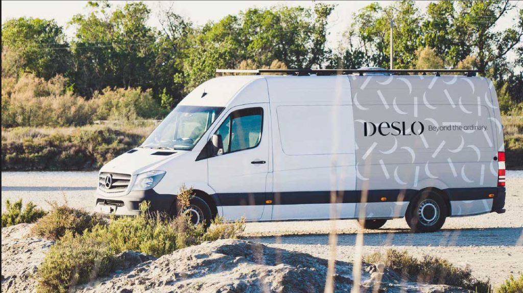 Deslo Stairs delivery truck on the road, ensuring sustainable and efficient transportation for custom staircases