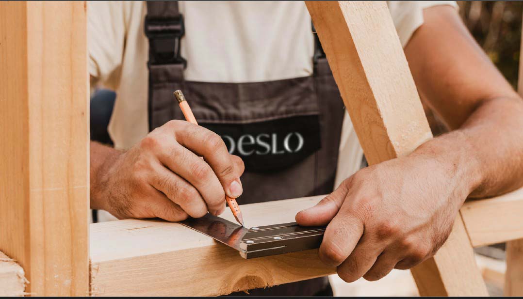 Skilled artisan carefully fabricating a wooden stair component, showcasing precision craftsmanship at Deslo Stairs.